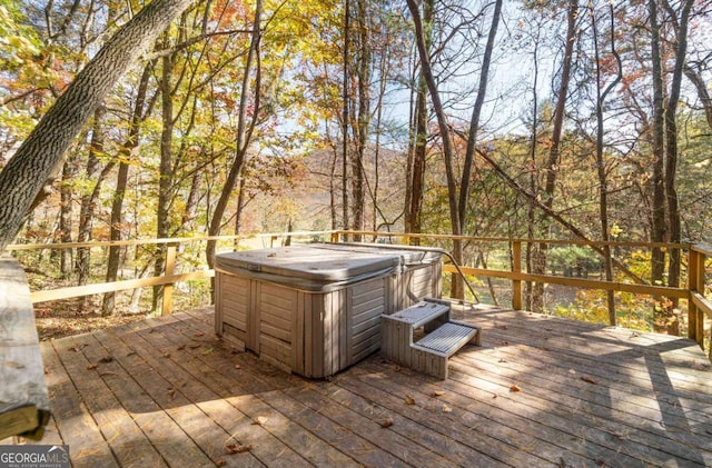 wooden deck featuring a hot tub