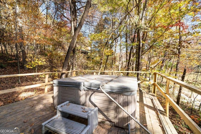 wooden deck with a hot tub