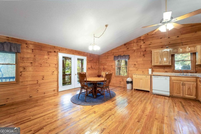 dining room featuring lofted ceiling, light hardwood / wood-style floors, and a healthy amount of sunlight