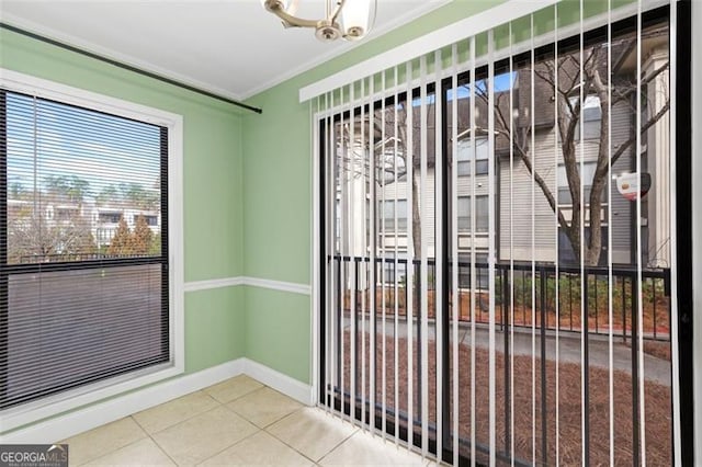 entryway featuring tile patterned flooring and crown molding