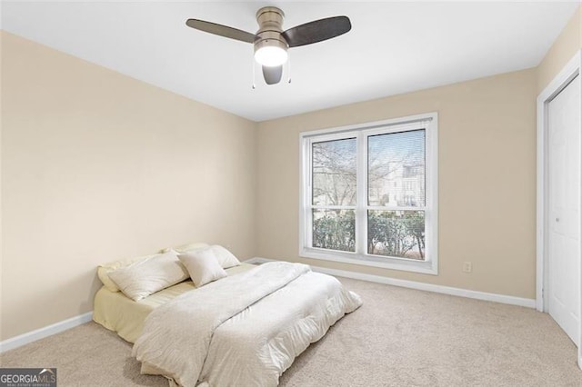 carpeted bedroom with ceiling fan