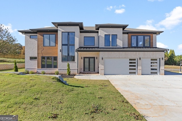 view of front of house featuring a garage and a front lawn