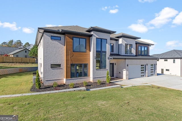 view of front facade with a garage and a front lawn