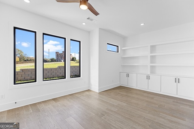 spare room with light hardwood / wood-style floors and ceiling fan