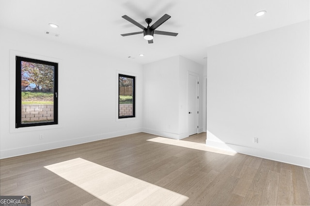 empty room featuring ceiling fan and light hardwood / wood-style flooring