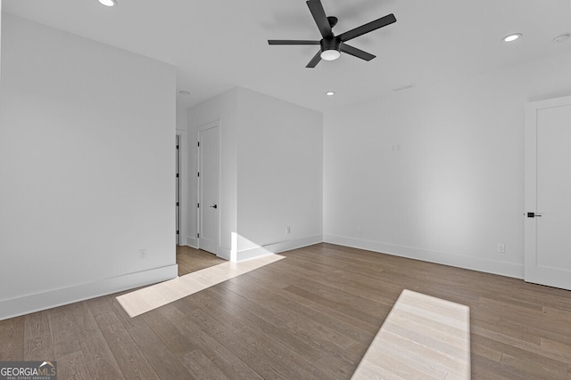 empty room with ceiling fan and light wood-type flooring