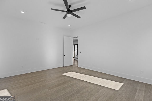 unfurnished room with ceiling fan and wood-type flooring