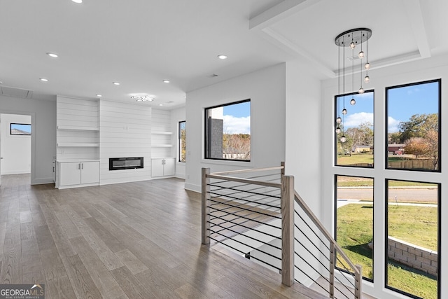 living room featuring hardwood / wood-style flooring and a large fireplace