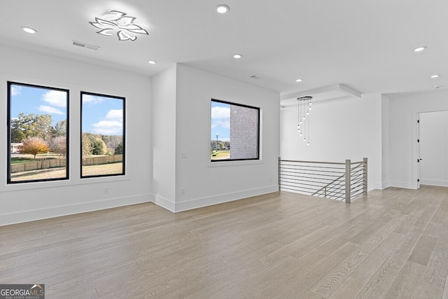 spare room with light hardwood / wood-style flooring