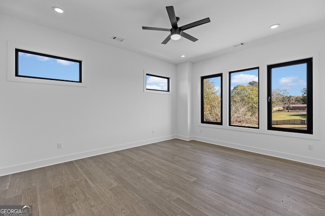 spare room with hardwood / wood-style flooring and ceiling fan