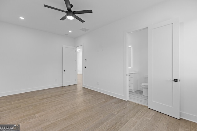 unfurnished bedroom featuring ensuite bathroom, ceiling fan, and light hardwood / wood-style floors