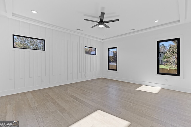 spare room with ornamental molding, ceiling fan, and light hardwood / wood-style flooring