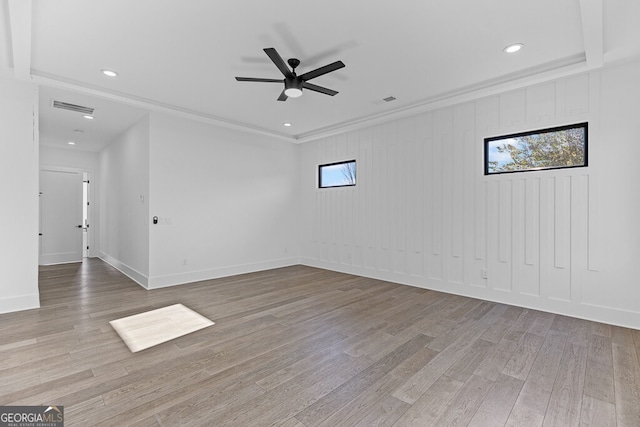 empty room featuring crown molding, ceiling fan, and light wood-type flooring