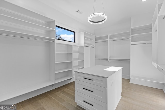 walk in closet featuring light hardwood / wood-style flooring