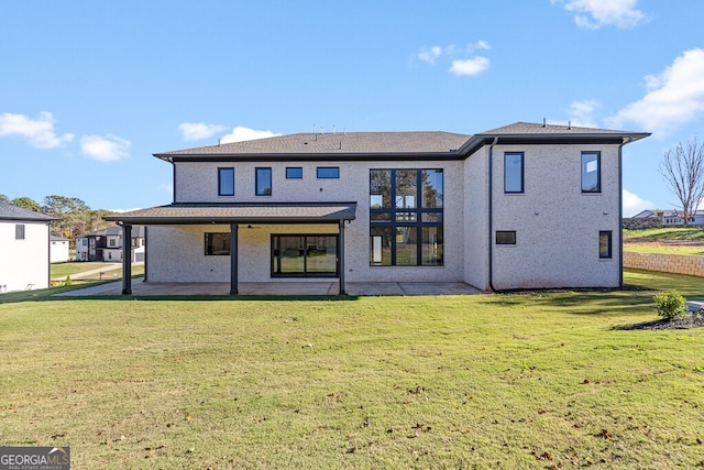 rear view of property featuring a yard and a patio area