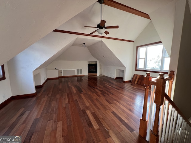 bonus room with vaulted ceiling and dark wood-type flooring