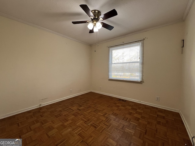 empty room featuring crown molding, ceiling fan, dark parquet flooring, and a textured ceiling