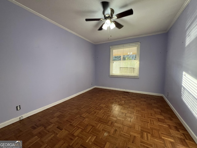 spare room featuring crown molding, ceiling fan, and dark parquet floors