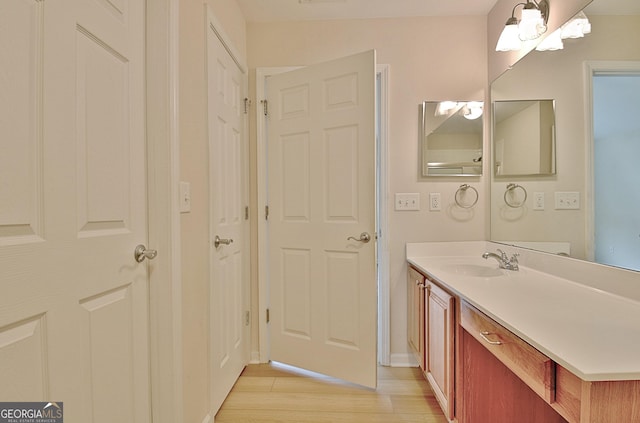 bathroom with vanity and hardwood / wood-style floors