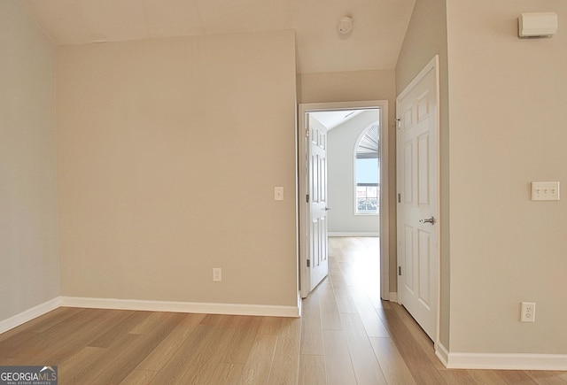 hallway with light hardwood / wood-style flooring