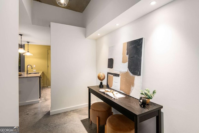 home office with concrete flooring and sink