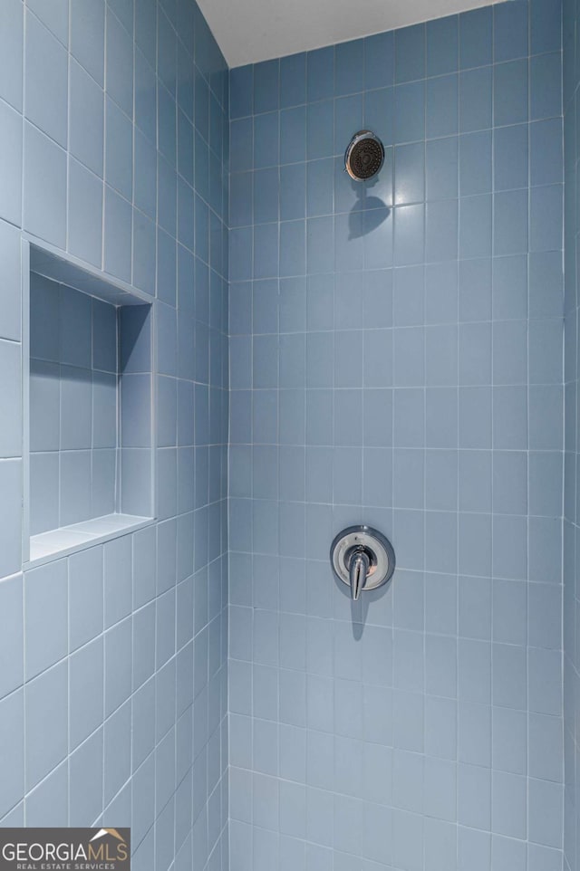 bathroom with a tile shower