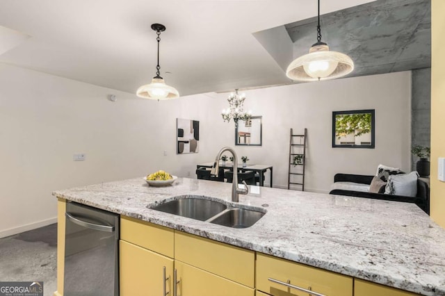 kitchen featuring dishwasher, sink, pendant lighting, and light stone counters