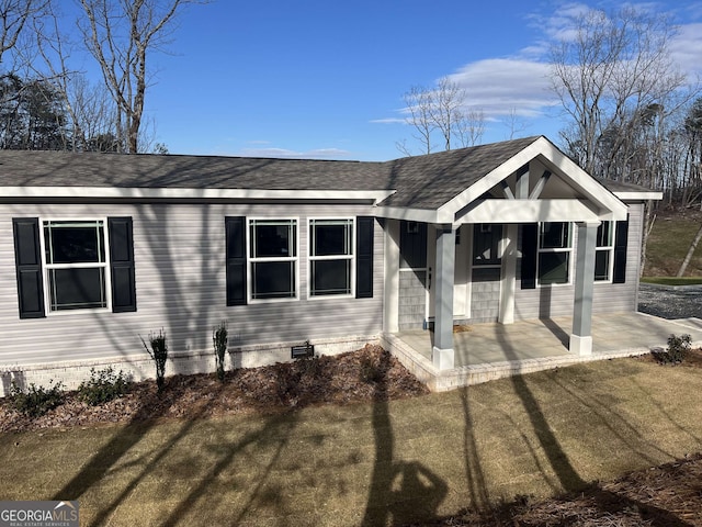 view of front of house featuring a front lawn and a patio