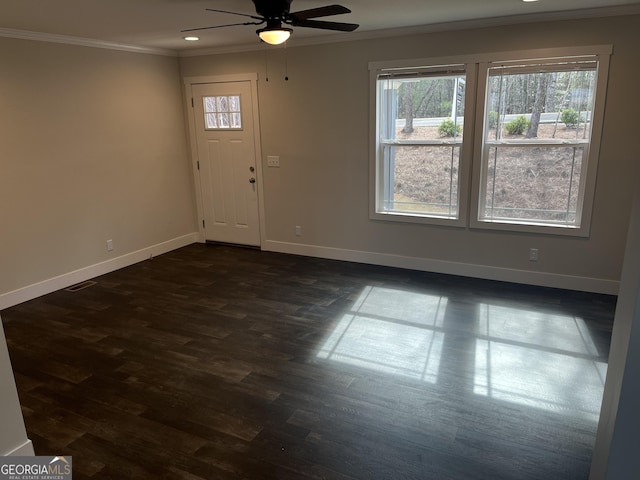 foyer entrance featuring dark hardwood / wood-style flooring, crown molding, and ceiling fan