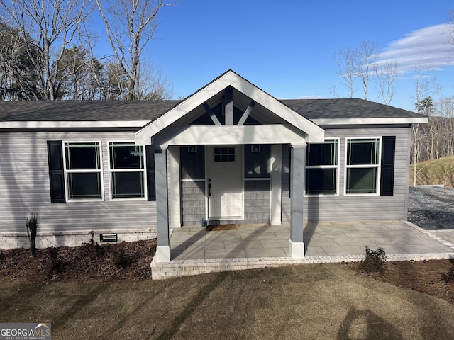 view of front of property with a patio and a front yard