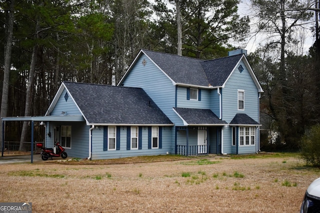 view of front of house with a front yard and a carport