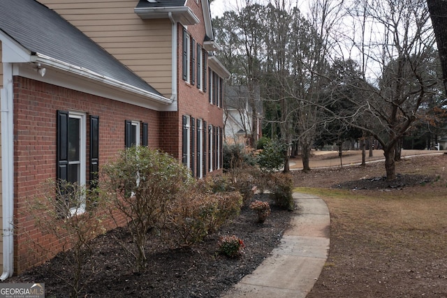 view of side of property with brick siding