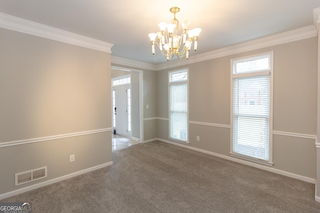 carpeted spare room with crown molding, a notable chandelier, baseboards, and visible vents