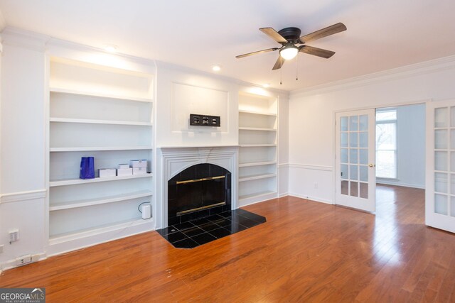 unfurnished living room with french doors, ceiling fan, ornamental molding, and dark hardwood / wood-style floors