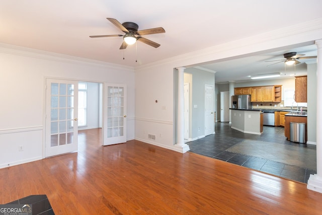 unfurnished living room featuring dark wood-type flooring, crown molding, french doors, and visible vents