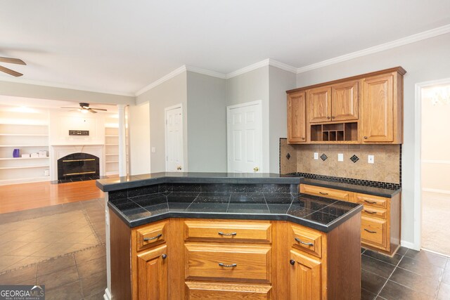 kitchen featuring sink, crown molding, stainless steel appliances, decorative columns, and backsplash