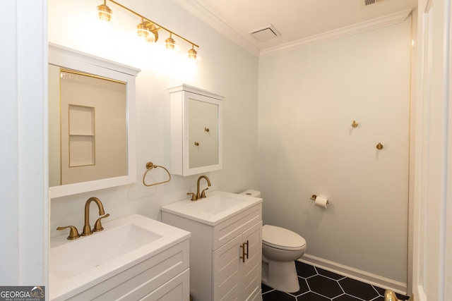 bathroom featuring toilet, ornamental molding, baseboards, and a sink