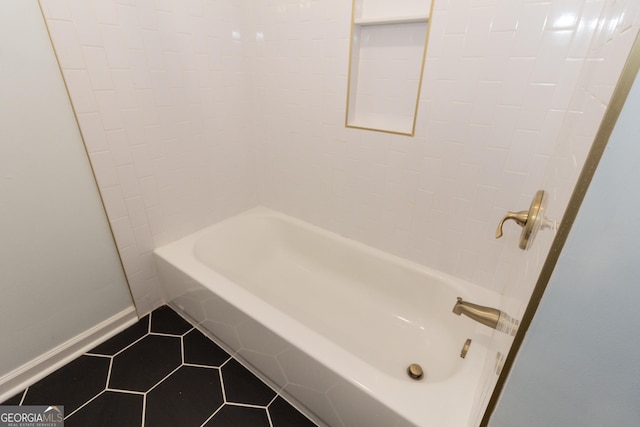 full bath featuring tile patterned flooring, baseboards, and shower / bathtub combination