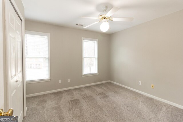 interior space featuring a raised ceiling, hardwood / wood-style floors, and ceiling fan