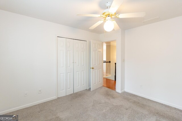 empty room with ceiling fan and carpet