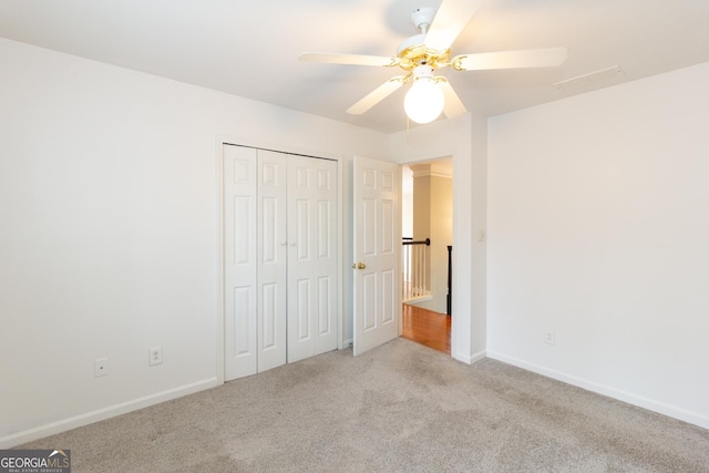 unfurnished bedroom featuring visible vents, a ceiling fan, a closet, carpet flooring, and baseboards