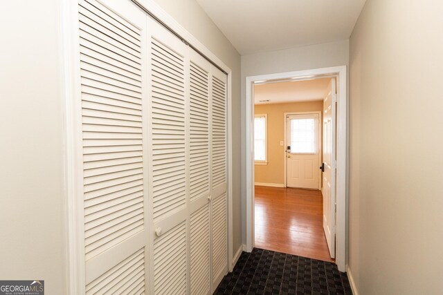 empty room with hardwood / wood-style flooring, ceiling fan, and a healthy amount of sunlight