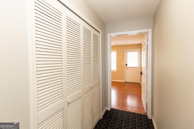 hallway featuring baseboards