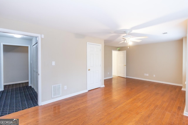 unfurnished bedroom with visible vents, baseboards, light wood-style floors, and a ceiling fan