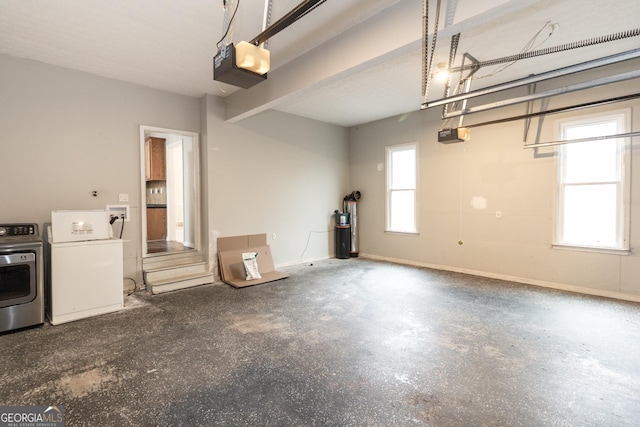 garage with baseboards, independent washer and dryer, and a garage door opener