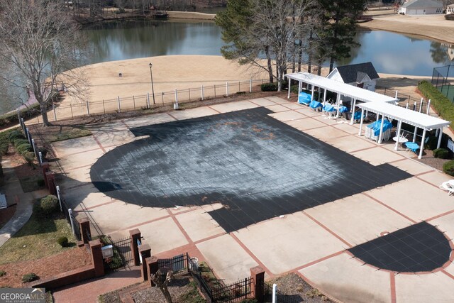 view of tennis court featuring a water view