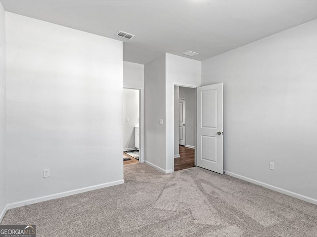 unfurnished bedroom with light carpet