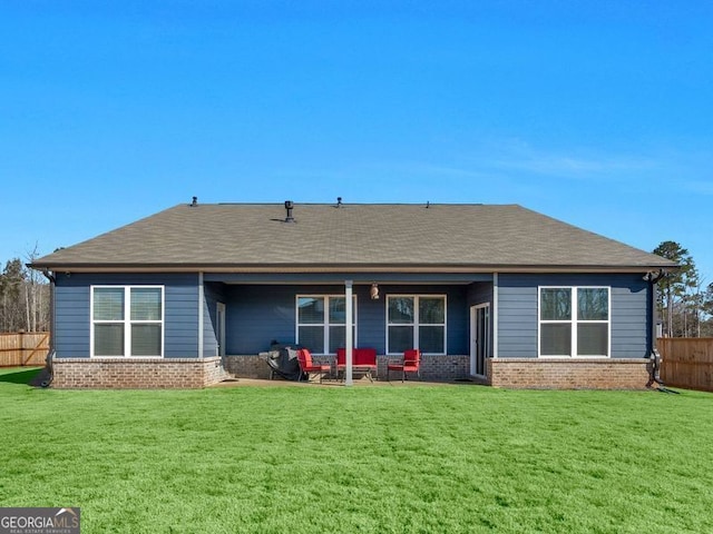 rear view of house featuring a yard and a patio area