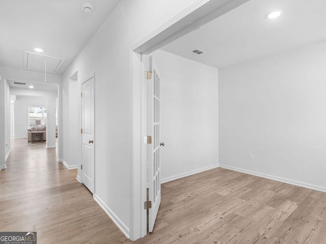 corridor with light hardwood / wood-style flooring