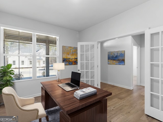 office area featuring french doors and light wood-type flooring